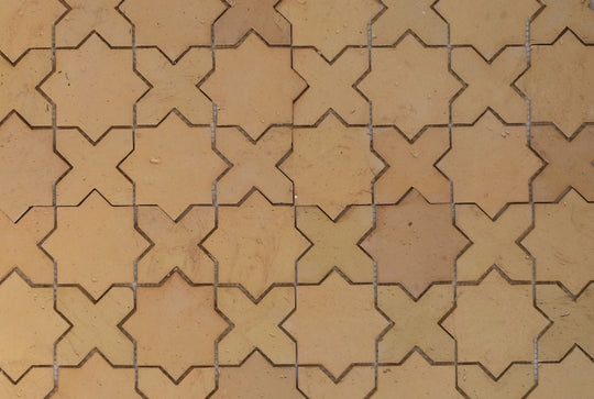 Pattern of star-and-cross shaped tiles in a grid on a beige background
