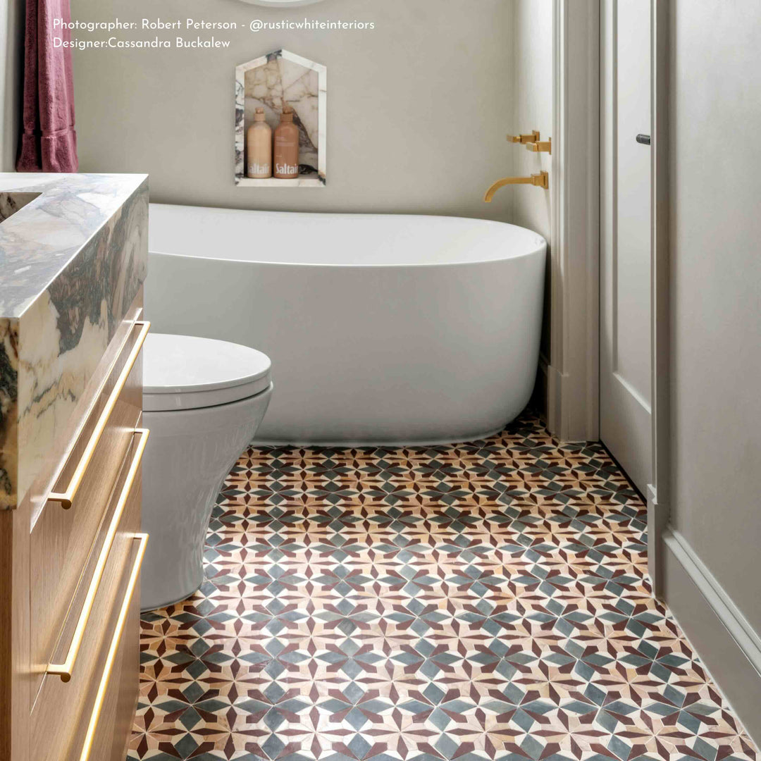 Modern bathroom with freestanding bathtub, patterned floor, and wooden vanity.