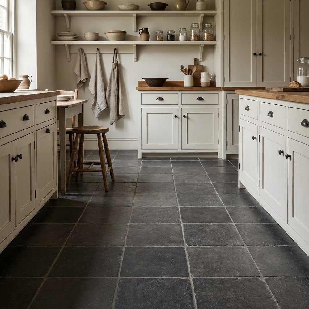 Kitchen with dark tiled floor, wooden countertops, and white cabinets.