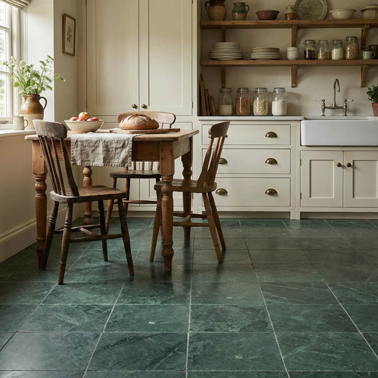 Kitchen with wooden dining table and chairs on a green tiled floor