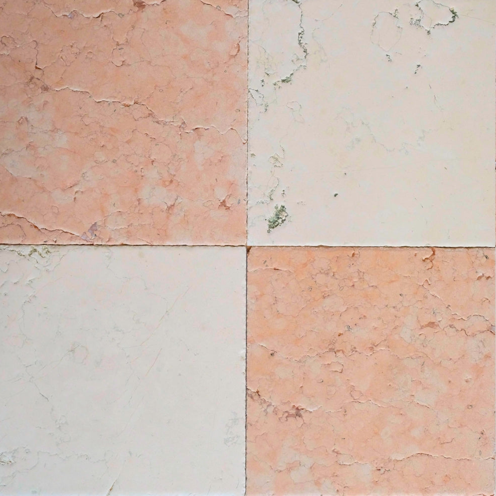 Four square tiles with different pink and beige marble patterns.