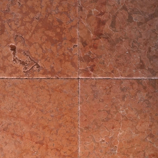 Four red tiles with a marble-like texture arranged in a grid pattern.