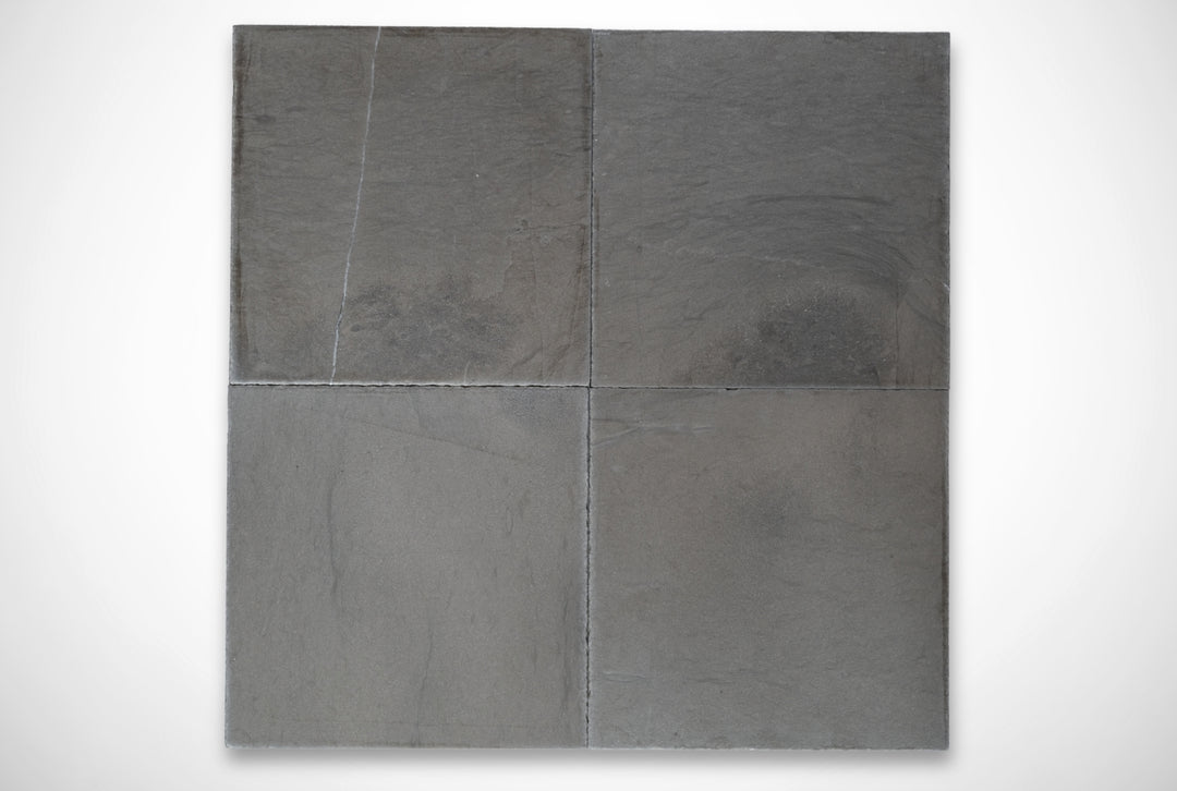 Four gray stone tiles on a white background