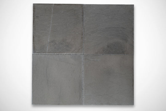 Four gray stone tiles on a white background