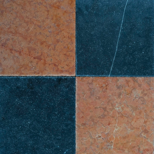 Four square tiles with different black and red patterns